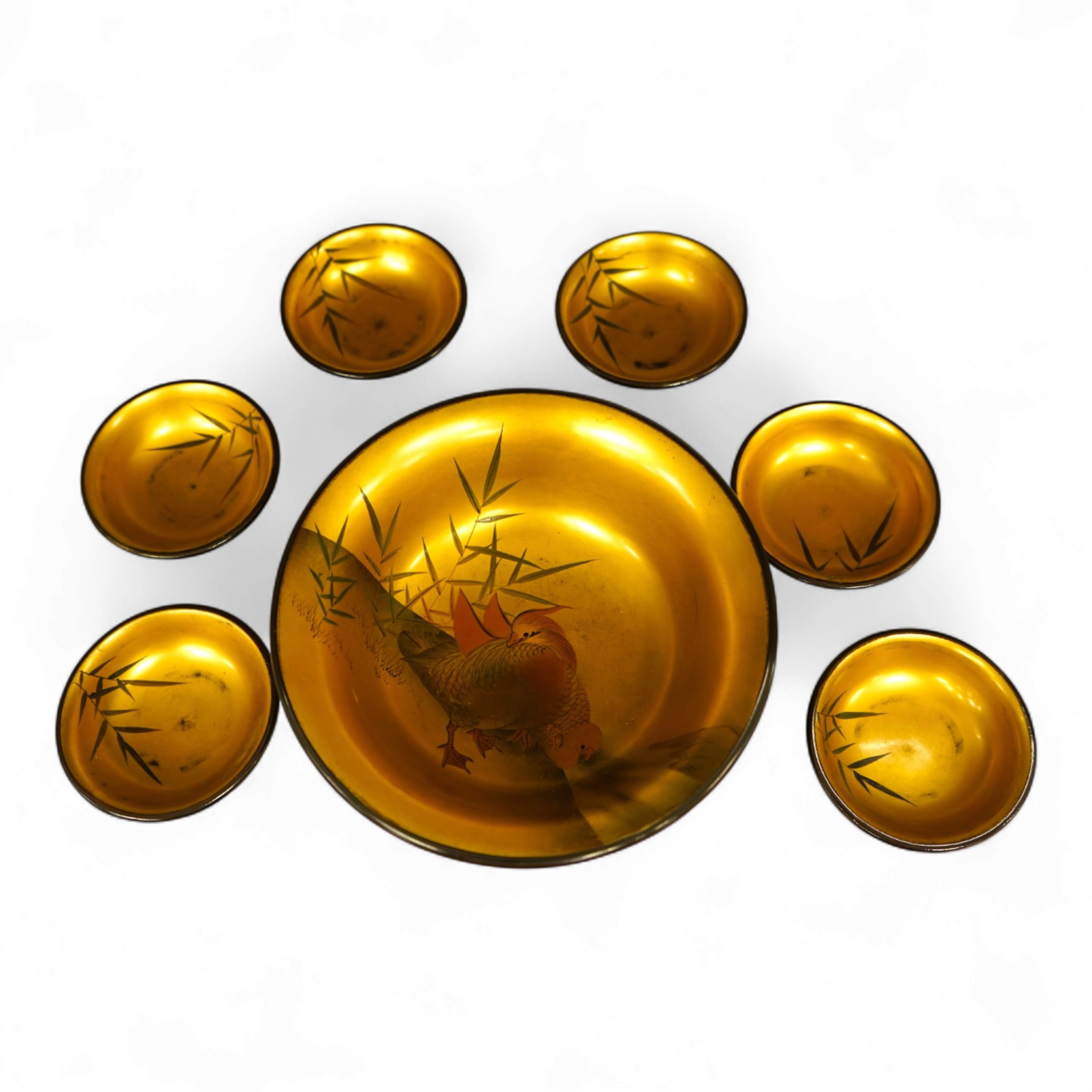 A Japanese lacquer bowl with gilt interior decorated with birds and six small dishes, largest 15cm in diameter